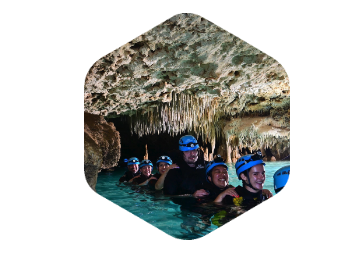 prophix team wading through water in a cave
